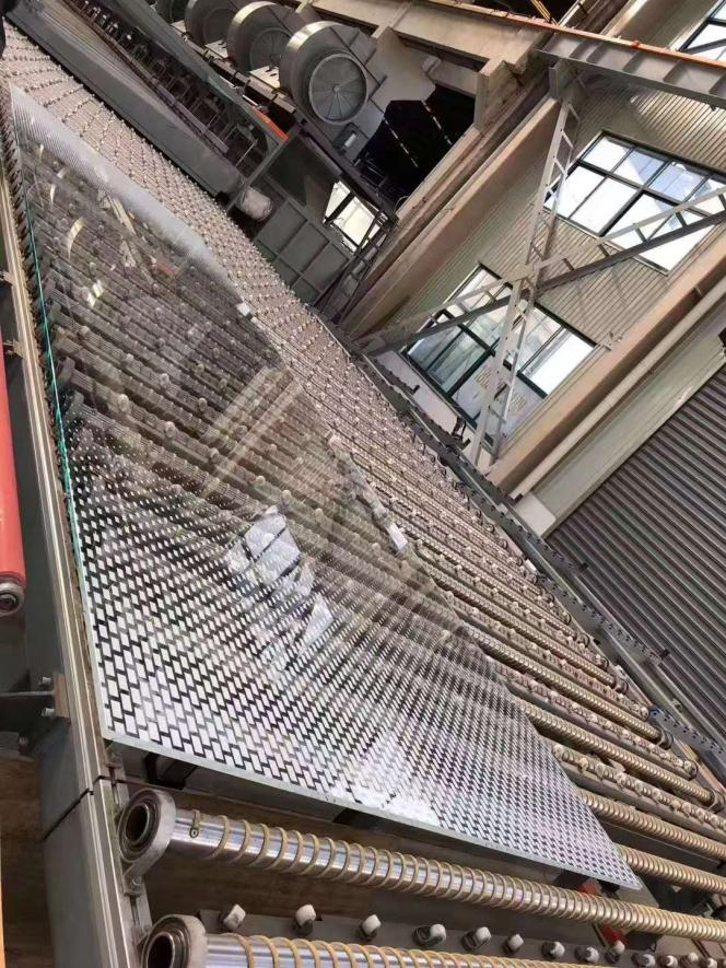 Installation of oversized glass panels on a modern building facade